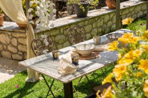 a table with cups and bowls on it in a garden at Kores Villas in Nydri +80 photos