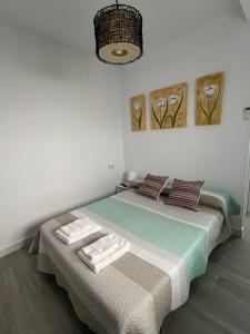 une chambre avec un lit avec des serviettes dessus dans l'établissement Family Apartment, à Arcos de la Frontera