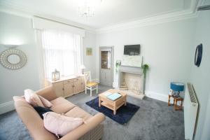 a living room with a couch and a fireplace at Teviotside Travel Inn in Hawick