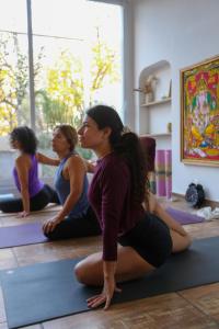 a group of women sitting on the floor in a yoga class at Casa Caravan - Plant Based Concept House in Buenos Aires