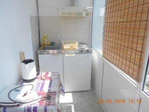 a small kitchen with a sink and a dishwasher at Doukas in Skala Rachoniou +61 photos