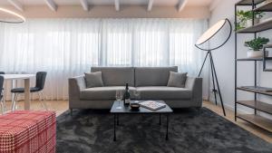 a living room with a couch and a table at Chiaroscuro in Brescia