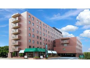 a large building with a bus stop in front of it at Urban Hotel Kyoto - Vacation STAY 10859v in Kyoto