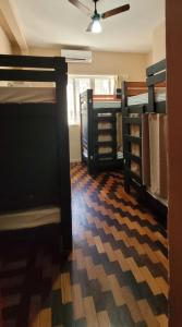 a room with several bunk beds in a room at Matianellu Hostel in Rio de Janeiro