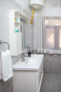 a bathroom with a white sink and a mirror at Eagle View Golf in Kigali +68 photos