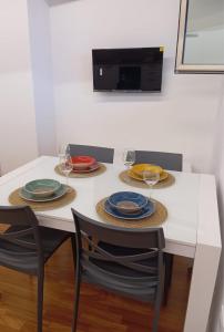 a table with four plates and wine glasses on it at aMare27 in Citta' Sant'Angelo +13 photos