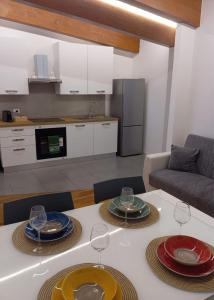 a kitchen with a table with plates and wine glasses at aMare27 in Citta' Sant'Angelo