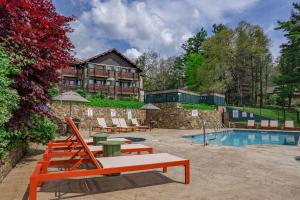 a resort with a pool and chairs and a building at Switzerland Inn in Spruce Pine