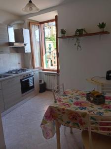 a kitchen with a table and a kitchen with a stove at Noor in Riomaggiore