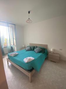a bedroom with a large bed with blue sheets at Noor in Riomaggiore