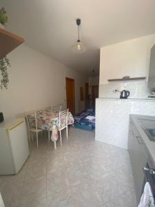 a kitchen with a table and a bed in a room at Noor in Riomaggiore +2 photos