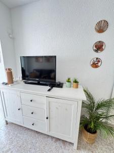 a white dresser with a flat screen tv on top at Casa Salamanca La Mata in Torrevieja