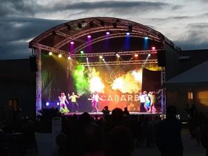 a group of performers on a stage at night at Mobil Home 3ch CONFORT Camping 4étoiles Les Charmettes 393 Proche FUN ZONE in Les Mathes