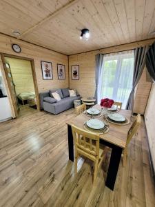 a living room with a wooden table and a couch at Roztoczańska Kryjówka in AdamÃ³w +18 photos