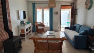 a living room with a blue couch and a fireplace at Tortuga in Dolus-d'Oléron