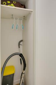 a bathroom with a hose hooked up to a wall at L'Explorer Rennes Métropole in Betton