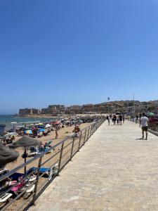 a pier with people on the beach and the ocean at Casa Salamanca La Mata in Torrevieja