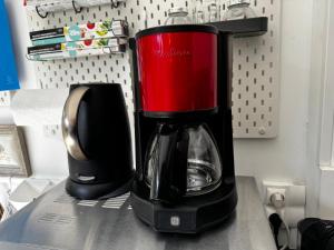 a black and red coffee maker sitting on a counter at Studio avec jardin sud proche bord de mer in Sainte-Maxime