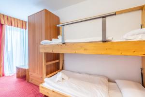 a bedroom with two bunk beds in a room at Hotel Polsa in Brentonico
