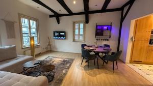 a living room with a table and a couch at Altstadt Perle in Limburg an der Lahn