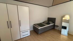 a small bedroom with a bed and a closet at Altstadt Perle in Limburg an der Lahn