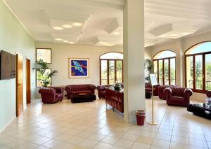 a large living room with couches and windows at Hotel Panoramic in San Vito lo Capo