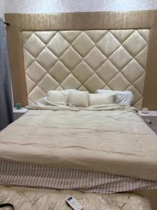 a bedroom with a large bed with a large headboard at Comfortable stay at RCCG Camp Mowe 2 Bedroom Bungalow Retreat in Mowe