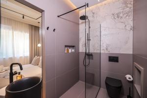 a bathroom with a shower and a sink and a toilet at Estium Luxury Rooms in Zadar