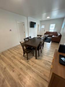 a living room with a table and chairs and a couch at Short Walk to Niagara Falls 6 Bedrooms in Niagara Falls