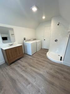 a bathroom with a tub and a sink and a tub at Short Walk to Niagara Falls 6 Bedrooms in Niagara Falls
