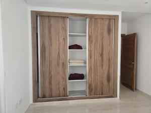 a wooden cabinet with glass doors in a room at Chez Touta in Hammam Sousse +3 photos