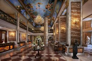 a lobby of a building with a chandelier at Hotel The Royal Plaza in New Delhi