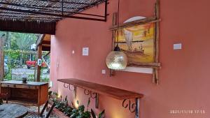 a room with a table and a painting on the wall at Pousada Oceano e Mar in Ilhabela