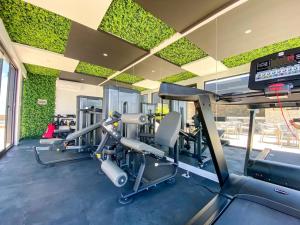 a gym with cardio equipment in a building at Downtown Playa Studio with Rooftop Pool Steps to Everything in Playa del Carmen