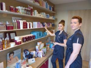 two women are standing in a pharmacyacistacistventory at Best Western Les Bains Hotel et SPA in Perros-Guirec