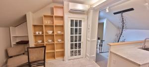 a kitchen with a staircase leading to a dining room at Couchiching Summer Escape in Orillia +20 photos