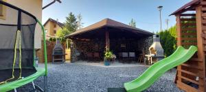 a gazebo with a playground with a green slide at Penzión u Jurka Zuberec in Zuberec