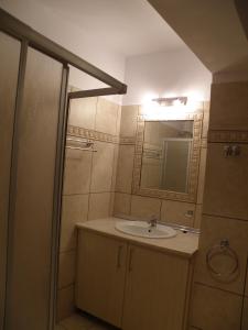 a bathroom with a sink and a mirror at Kate Apartments in Kokkari