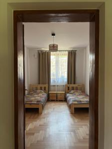 a room with two beds and a mirror at Pod Ogrodami in Stary Sącz