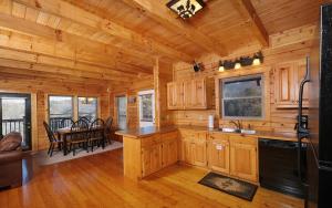 a kitchen and dining room of a log cabin at Red Cedar Lodge in Sevierville