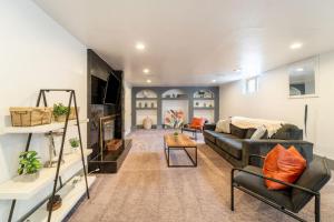 a living room with a couch and a table at Renovated 4BR Escape Luxe Comfort and Hot Tub in Westminster