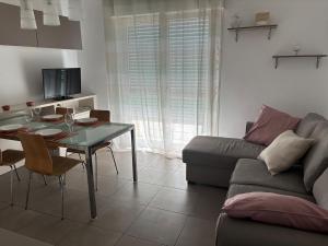 a living room with a table and a couch at Residenza Torricelli in Riccione