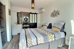 a bedroom with a large bed with pillows on it at Les Gites de Namaskar in Labégude +25 photos