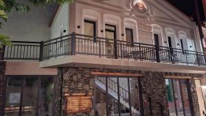 a building with a balcony on top of it at John&Nansy Cozy Apartment 1 in Plomari
