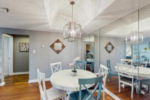 a dining room with a white table and chairs at 303 Sugar Top Dr #2901 in Sugar Mountain