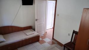 a small bedroom with a bed and a chair at Елиани in Gabrovo