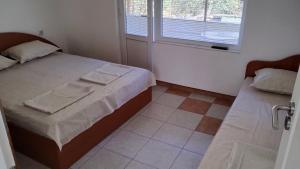 a small bedroom with a bed and a window at Елиани in Gabrovo