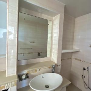 a bathroom with a sink and a mirror at Sandy Lane Escape - Grand Baie in Grand Baie
