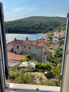 a view from a window of a town and water at Apartment Blue Haven Valun in Valun +14 photos