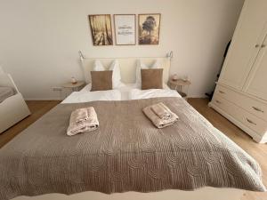 a bedroom with a large bed with two towels on it at Ferienwohnung Gutzeit in Stadtilm